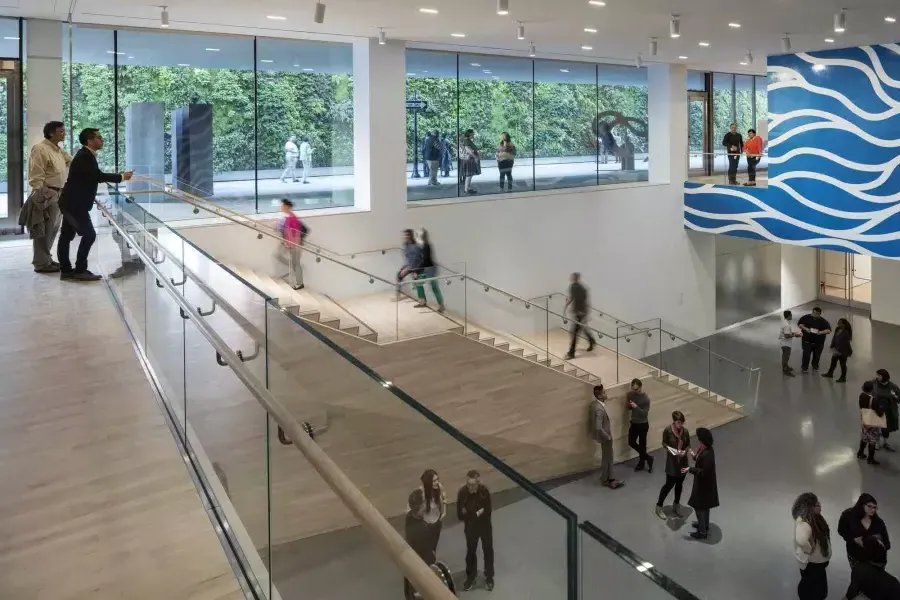 People walk up and down stairs in an airy atrium at the San Francisco Museum of Modern Art (SFMOMA).